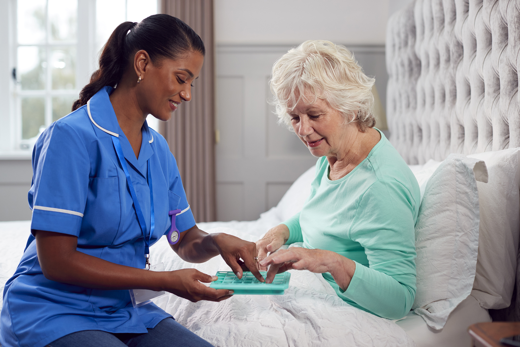 Female Care Worker In Uniform Helping Senior Woman At Home In Tampa bay Florida resolve care and companion services